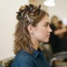 Woman with feathered layers, top section clipped up, lower hair loose and ready to blow-dry in seventies technique