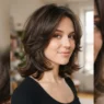 Woman with square-layered nineties cut showing face-framing layers and flicked ends at collarbone level in soft even light