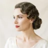 Woman with sleek 1930s Old Hollywood finger waves in bridal styling against soft ivory background